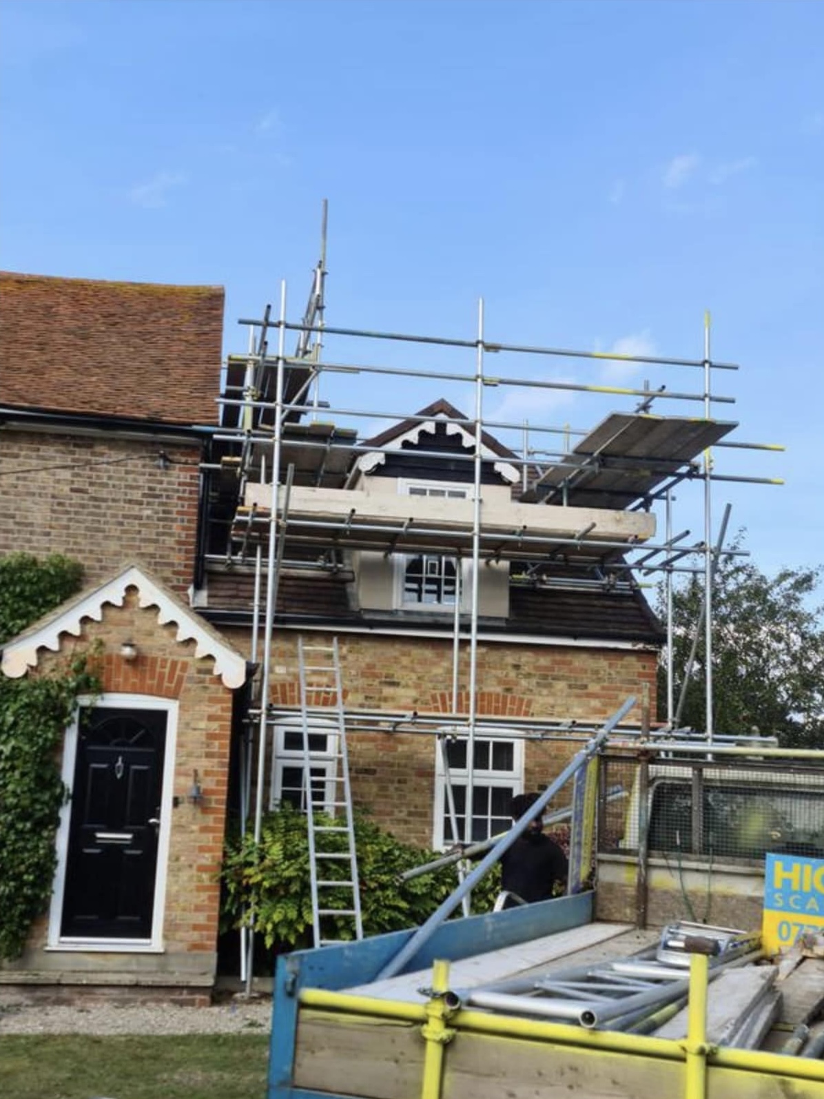 Decorator preparing interior wall before painting in an Essex home.